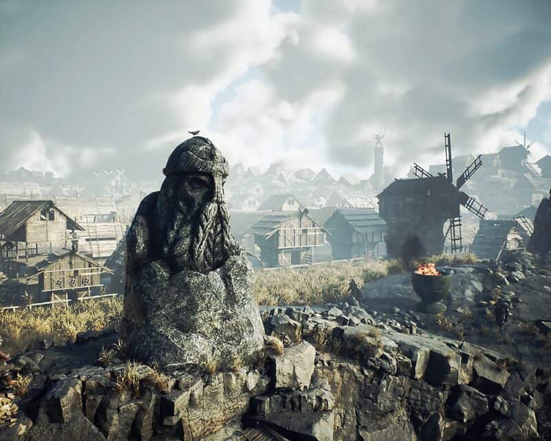 Wikińska osada, posąd nordyckiego boga, w oddali wiatrak