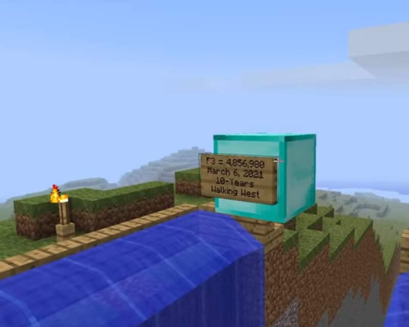 Screen z Minecraft Far Lands or bust - przy wodospacie stoi konstrukcja wzniesiona z okazji dziesięciolecia podróży