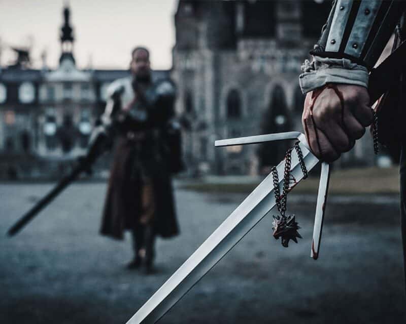 Bilety na LARP Szkoła Wiedźminów, dwaj mężczyźni stoją naprzeciwko siebie z mieczami w rękach