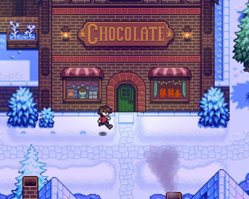 Haunted Chocolatier zapowiedź - na obrazku widzimy uroczą postać biegnącą w kierunku budynku z szyldem „Chocolate”.