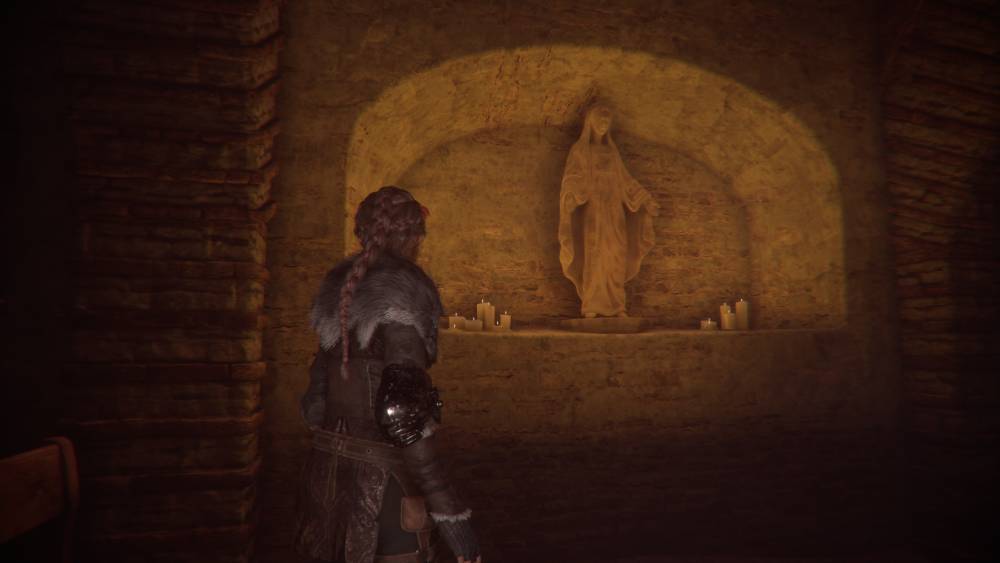 Screen z A Plague Tale: Innocence – Amicia w kaplicy