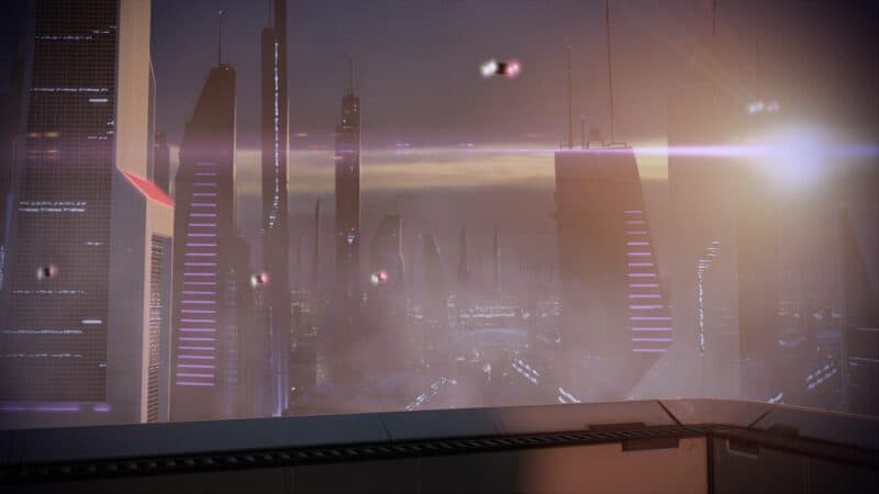 recenzja Mass Effect 2: Legendary Edition – widok z Illium zrobiony za pomocą trybu fotograficznego, widać na nim wieżowce, lecące samochody, jak i łunę światła