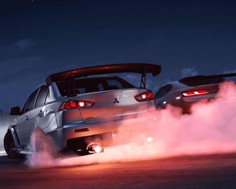 Recenzja gry Forza Horizon 5: kadr z produkcji. Na grafice znajdują się dwa driftujące samochody.