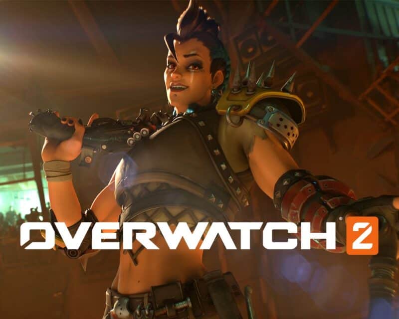 kiedy Overwatch 2 za darmo, Blizzard Entertainment, Microsoft – na grafice znajduje się uśmiechnięta kobieta z fioletowymi włosami, ubrana jest w lekką zbroję z części samochodów lub innych maszyn, na ramieniu opiera dubeltówkę
