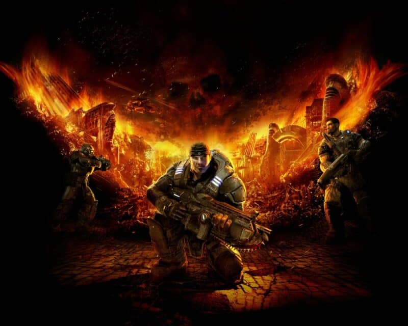 Marcus Fenix przykucający w rynsztunku bojowym na tle miejskiego pobojowiska. Chmura układa się w czaszkę z logo gry.