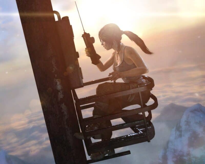 Kolejna gra z serii Tomb Raider od Crystal Dynamics – na screenie bohaterka gry, Lara Croft, siedzi na słupie telegraficznym z krótkofalówką, w tle zachód słońca
