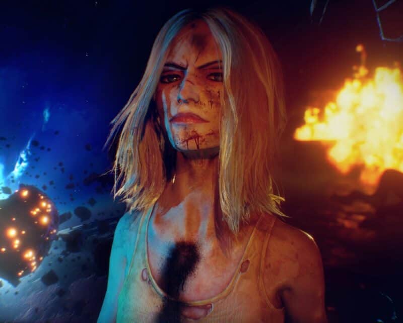 Zapowiedź gry Judas - na obrazku zakrwawiona blondynka o złym spojrzeniu, która spogląda na osobę grającą, w tle ogień