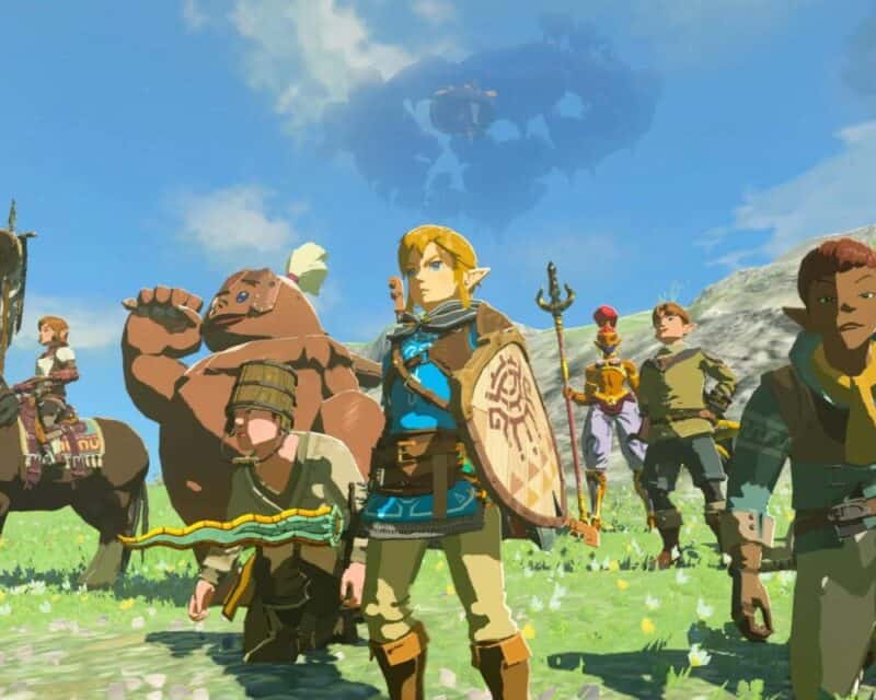 the legend of zelda tears of the kingdom wyniki sprzedaży, na zdjęciu widać grupę postaci z fantastyki, na czele której stoi chłopak o jasnych włosach, uzbrojony w tarczę i miecz