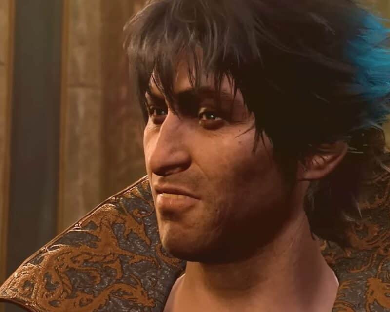 grafika z gry Baldur's Gate 3, widać na niej twarz białego mężczyzny o ciemnych oczach i włosach, ma na sobie eleganckie szaty, w tle kamienne ściany