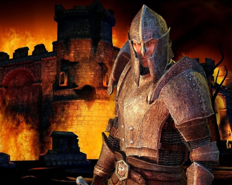 the elder scrolls oblivion czy będzie remake remaster, na zdjęciu po prawej stronie widać mężczyznę ubranego w zbroję, który spogląda w stronę widza, a w tle znajduje się płonący zamek