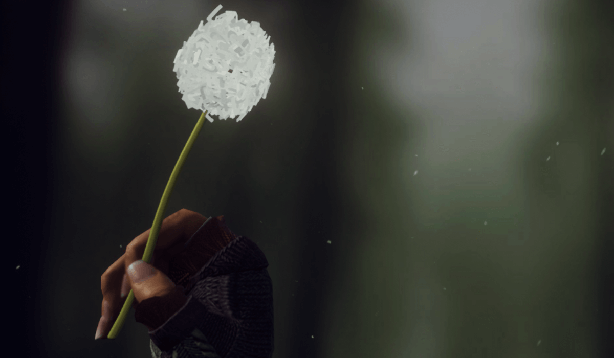 Grafika przedstawia dłoń głównej bohaterki, Edith, trzymającej dmuchawca.