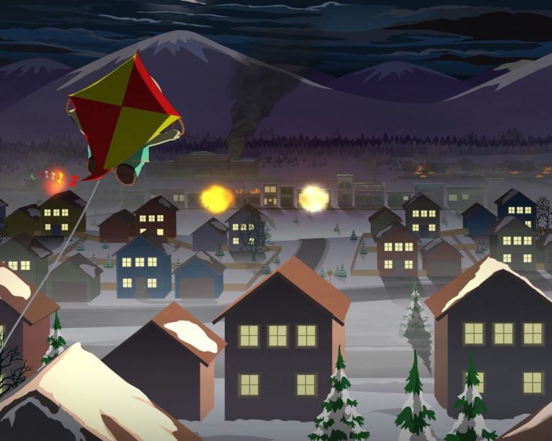 obrazek z gry South Park: The Fractured But Whole, widać na niej postać lecącą na żółto-czerwonym latawcu, w tle miasteczko nocą, na drugim planie wybuchy i czarny dym