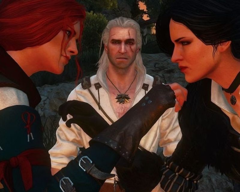 Na obrazku są przedstawione Triss I Yennefer, które mierzą się na rękę,a za nimi Geralt z Rivii.