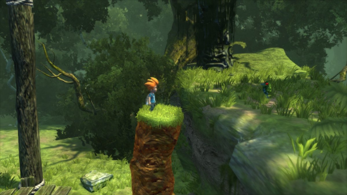 Na obrazku widać chłopca stojącego na ogromnym wzniesieniu. Wokół widać zielony las