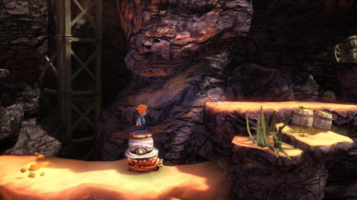 Screen z gry "Max: The Curse of Brotherhood", na obrazku widać chłopca stojącego na stworze przypominającym żółwia. Wokół widzimy skały i piasek