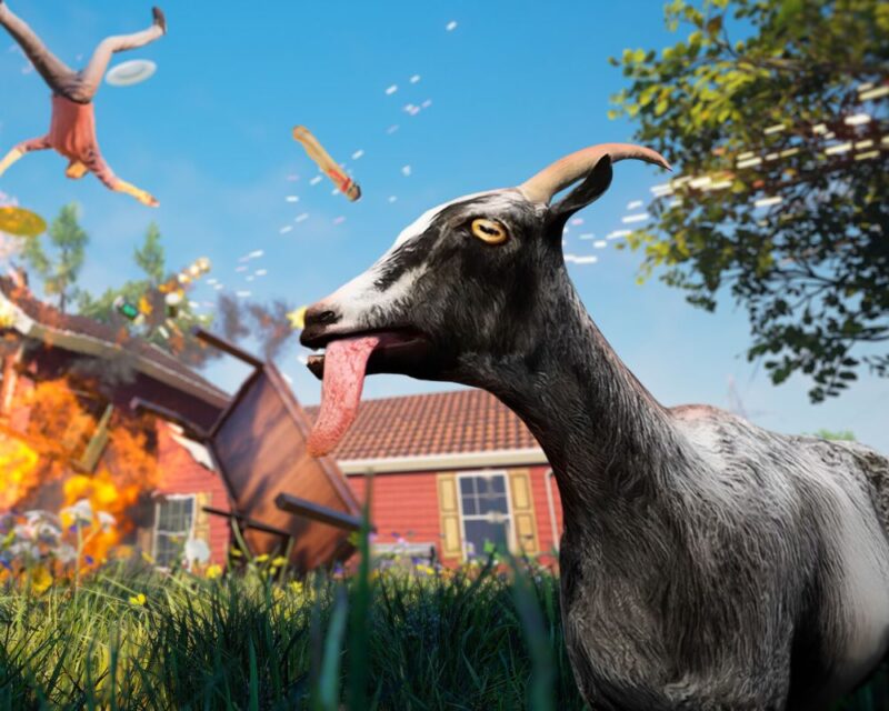 Goat Simulator Remastered zapowiedź, na grafice widzimy szarą kozę z wywalonym na bok językiem, za nią jest domek o czerwonawych ścianach, nad którym przelatuje człowiek, zaś domek się pali