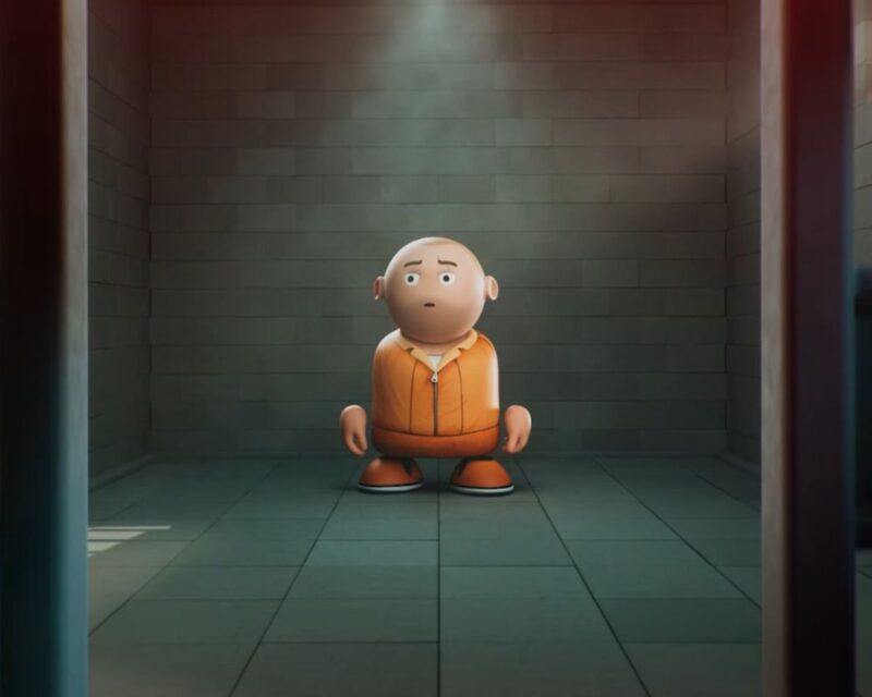 Prison Architect opóźnione bezterminowo, na grafice widizmy ludzika z pomarańczowym więziennym stroju, stojącego w pustej ciemnej celi