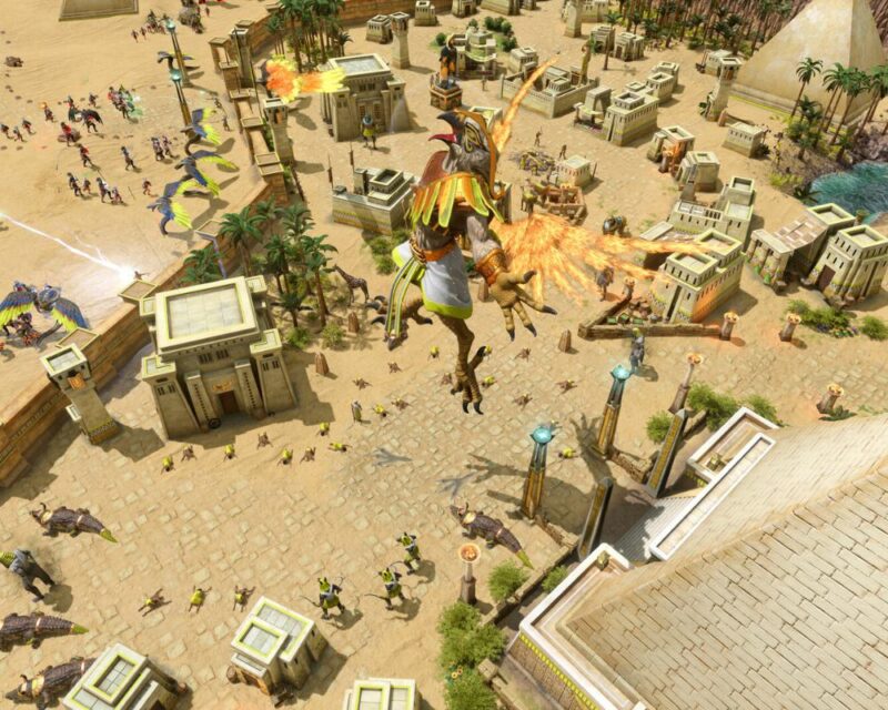 screenshot z gry Age of Mythology Retold, widzimy rzut z lotu ptaka na powstające starożytne egipskie miasto, nad nim unosi się Ra o ciele człowieka i głowie ptaka