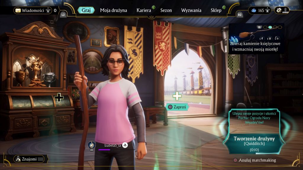 Kobieta w okularach trzyma miotłę. Znajduje się w szatni, przed wejściem na boisko. W tle widać komodę z pucharami. U góry ekranu są napisy z opcjami, jakie daje rozgrywka.