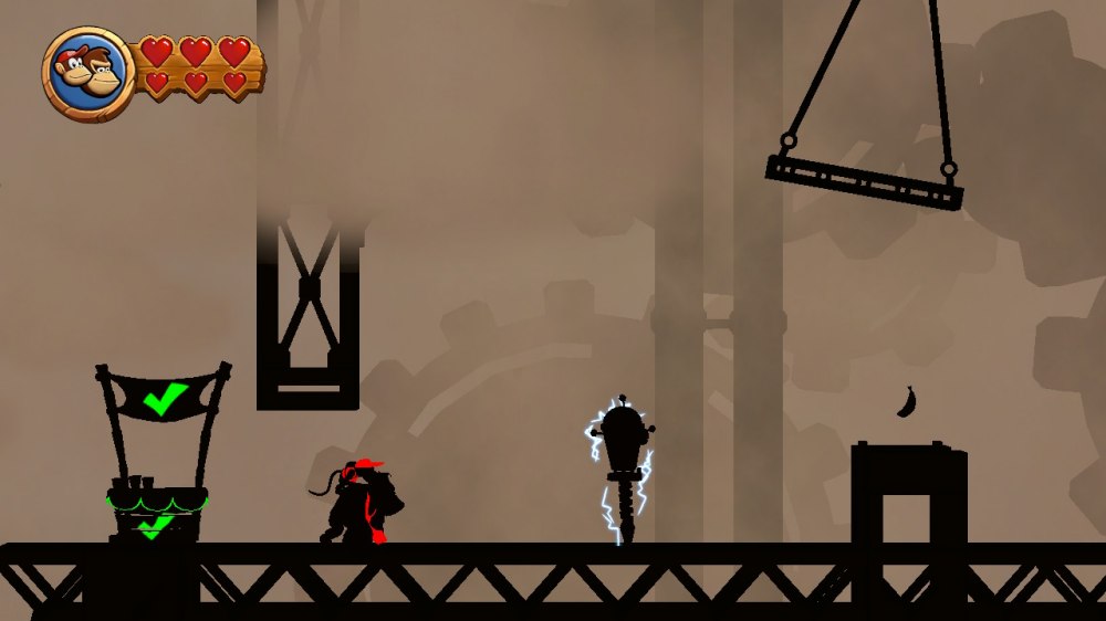 Zadymiona fabryka z gry Donkey Kong Country Returns HD – na zdjęciu widzimy kontury postaci Donkey Konga i Diddy'ego Konga oraz cienie fabrycznych elementów.