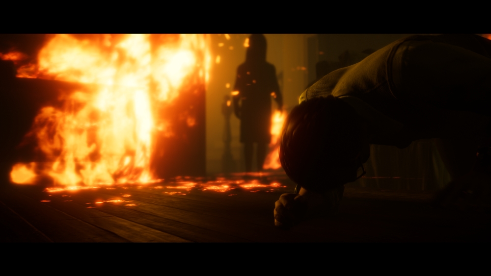 Przerażający pożar. W tle postać, na pierwszym planie ktoś leży. Recenzja The Dark Pictures Anthology: Little Hope
