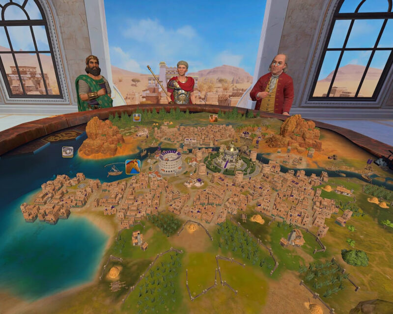 Na pierwszym planie widzimy okrągły stół do gry strategicznej, przypominający planszę do gry w cywilizację. Na stole rozciąga się szczegółowa mapa z różnorodnymi terenami: obszarami miejskimi z licznymi budynkami, terenami zielonymi z lasami i polami, wodami z żaglówkami oraz górami. W centrum mapy znajduje się rozbudowana metropolia z charakterystycznymi budowlami, takimi jak koloseum i inne monumentalne konstrukcje. Nad stołem stoją trzy postacie, które wydają się być graczami lub obserwatorami. Po lewej stronie stoi mężczyzna z ciemną brodą, ubrany w zieloną szatę ze złotymi zdobieniami i złotą opaskę na głowie. Pośrodku znajduje się postać w srebrnej zbroi z czerwonymi elementami, trzymająca w ręku berło lub laskę. Po prawej stronie stoi łysiejący mężczyzna w czerwonej marynarce i brązowej kamizelce, trzymający w dłoniach jakiś przedmiot. W tle, za postaciami, rozciąga się malowniczy krajobraz z górami i błękitnym niebem. Po obu stronach znajdują się duże okna z łukowym górnym elementem, przez które widać fragmenty zabudowań w oddali. Całość sceny sprawia wrażenie rozgrywki w wirtualną lub stołową grę strategiczną osadzoną w historycznym lub fantastycznym świecie.