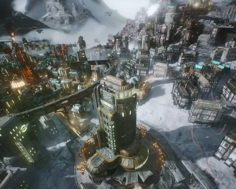 Grafika z gry **Frostpunk 2** przedstawia rozbudowane, przemysłowe miasto w ośnieżonym krajobrazie. W centrum widać wysoki budynek otoczony siecią ulic, mostów i fabryk, z których unoszą się kłęby dymu. Miasto jest oświetlone ciepłym światłem lamp i pieców, kontrastującym z chłodnym, zimowym otoczeniem gór i lodu.