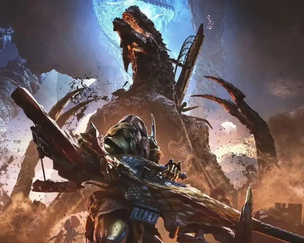 Na ilustracji z gry „Monster Hunter Wilds” widać łowcę w ciężkim, kolczastym pancerzu, celującego ogromną bronią w potężnego potwora wynurzającego się z ziemi. W tle unoszą się tumany kurzu i odłamki skał, a sceneria przypomina skalistą pustynię rozdartą przez siły natury.