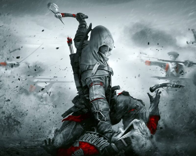 Dynamiczna scena z gry Assassin’s Creed III przedstawiająca zamaskowanego asasyna w trakcie brutalnej walki – bohater z uniesioną bronią atakuje przeciwnika, a w tle widać chaos pola bitwy, żołnierzy z muszkietami, dym i unoszące się odłamki.
