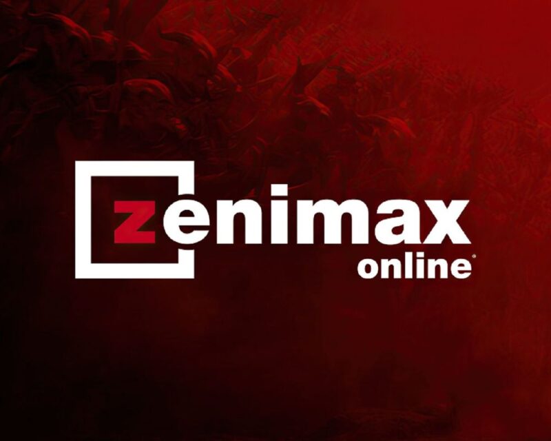 Logo ZeniMax Online – biały napis „zenimax online” z charakterystyczną literą „Z” w kwadracie, umieszczony na czerwonym, mrocznym tle z subtelną, fantasy’ową teksturą.