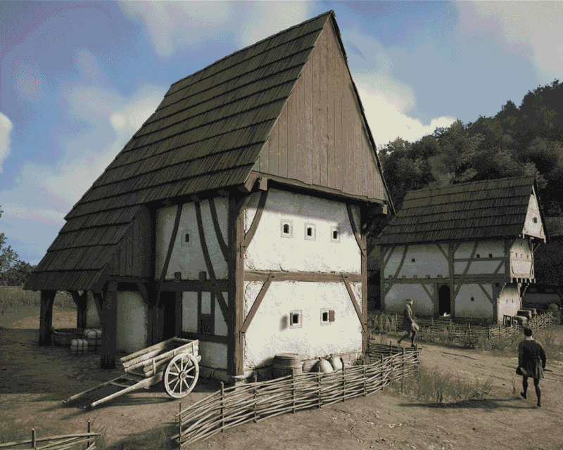 Dwa średniowieczne domy o konstrukcji szachulcowej z wysokimi, stromymi dachami. Przed budynkami widoczne są drewniane ogrodzenia, wóz oraz kilka postaci poruszających się po ubitej drodze. W tle znajduje się zalesione wzgórze i jasne, lekko zachmurzone niebo. Grafika z gry Manor Lords.