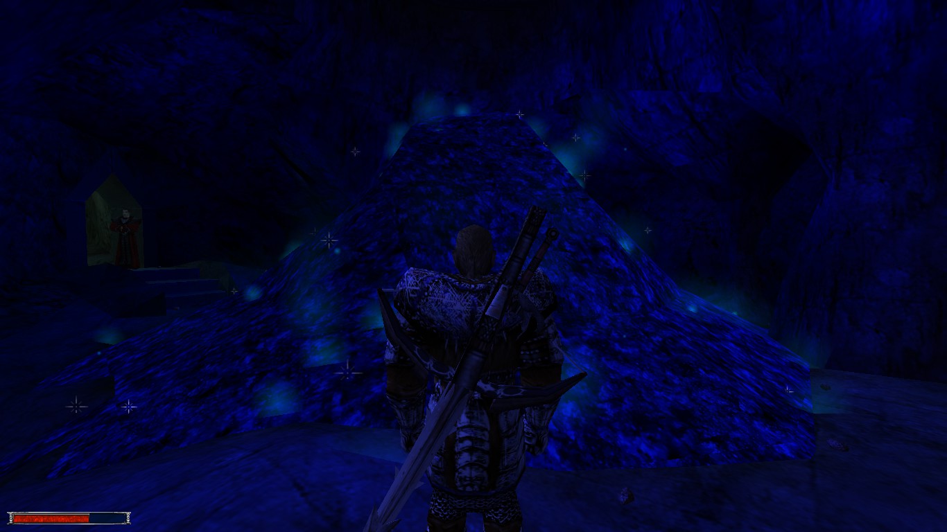 Ubrany w szarą zbroję z mieczem i kuszą na plecach Bezimienny z gry Gothic stoi przed wielkim kopcem niebieskiej rudy