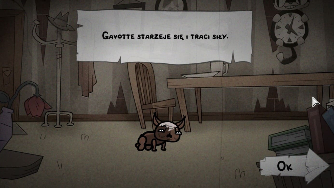 Zrzut ekranu z gry Mewgenics przedstawiający starszego, brązowego kota o imieniu Gavotte siedzącego w ponurym pokoju. Nad postacią widnieje biały zwój z polskim tekstem: „Gavotte starzeje się i traci siły”. W tle widać zwiędnięty kwiat, stół z krzesłem oraz wieszak, co podkreśla melancholijny nastrój sceny. W prawym dolnym rogu znajduje się przycisk „Ok” w kształcie strzałki.