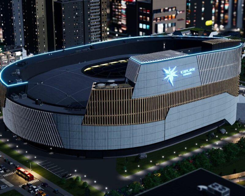 Obrazek prezentuje nowy budynek charakterystyczny Iceflake Arena, który ma zostać udostępniony za darmo 18 marca 2026 roku z okazji 11 urodzin marki Cities: Skylines. Obiekt trafi do drugiej części gry. To rodzaj zabudowanego stadionu z nowoczesną fasadą. Został zaprezentowany w nocnej scenerii w ruchliwym mieście. Na froncie elewacji widnieje logo studia Iceflake Studios.