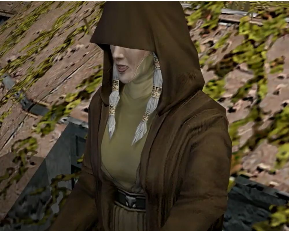 Ujęcie prezentuję Kreię, jedną z postaci, która towarzyszyła protagoniście gry Star Wars: Knights of the Old Republic II: The Sith Lords. Ubrana jest w brązowy płaszcz z głęboko naciągniętym kapturem. Pod nim ma oliwkową szatę. Siwe włosy ma związane w dwa spływające po bokach głowy kuce z ozdobnymi obręczami.