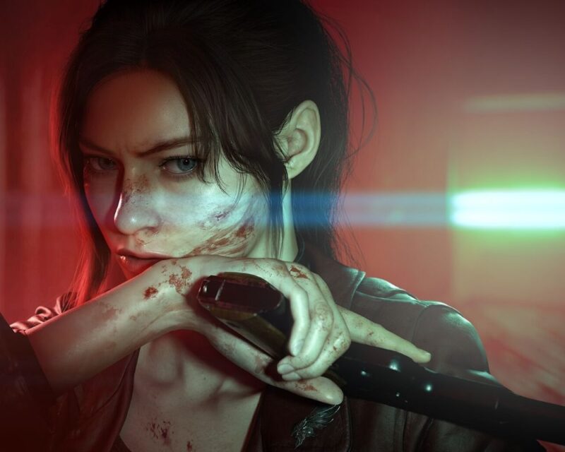 Grafika z gry Resident Evil Veronica przedstawiająca Claire Redfield w bliskim ujęciu. Bohaterka ma ciemne włosy związane z tyłu, zabrudzoną i zakrwawioną twarz oraz dłonie. Opiera rękę na trzymanej broni, a w tle widoczne są czerwone i zielonkawe światła rozmyte przez efekt głębi ostrości.